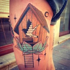 a woman's leg with a tattoo on it that has an image of a house and stairs