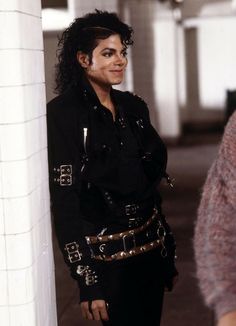 michael jackson as michael jackson in the movie michael jackson is shown standing next to a column