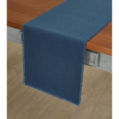 a blue table runner on top of a wooden table