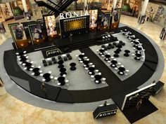 an artistic rendering of a display in a shopping mall with black and white decorations on the floor