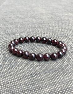 Wear the power of love and passion around your wrist with this red garnet bracelet!   Whether you're looking to add some extra romance to your life or you just want to feel confident and sexy, this bracelet is sure to give you that boost! It is the perfect accessory for anyone looking to increase their love and passion. Red garnet is known to promote positive energy and increase feelings of love, joy, happiness, and passion. Adjustable Garnet Bracelet Gift, Adjustable Garnet Bracelets Gift, Adjustable Garnet Bracelet As Gift, Red Garnet Bracelets As Gift, Red Garnet Bracelet For Gift, Red Garnet Bracelet As Gift, Red Garnet Bracelet Gift, Burgundy Round Beads Bracelet As Gift, Feelings Of Love