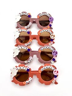 "\"LETS GO GHOULS\" adorable HALLOWEEN SUNNIES!! Each pair is handcrafted by me. Using various beads, Charms, Rhinestones, and fun details. On our adorable boho flower sunnies!! Choose between our gorgeous PLUM OR RUST color. * Anti-Glare * UV Protection (UVA & UVB) * Durable and shatterproof  * They open and close smoothly  * Each item is made to order and will be ready to ship in 5-7 business days! If you need your order sooner. Please check out my \"RUSH ORDER OPTION\".  https://www.etsy.com/EyeCandyandFluff/listing/1286351273/rush-my-order-please *SHOP DISCLAIMER/WAIVER!  * Do NOT let your child put the sunglasses in their mouth as beads can become detached.    Always monitor and supervise while children are wearing these. The shop assumes no responsibility for sunglasses made. Sizing- Halloween Sunglasses Diy, Halloween Sunnies, Halloween Sunglasses, Lets Go Ghouls, Diy Sunglasses, Embellished Sunglasses, Diy Glasses, Beaded Sunglasses, Personalized Sunglasses