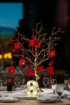 the table is set with red lanterns and place settings for two people to sit at