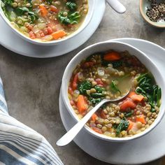 two bowls filled with soup on top of a table