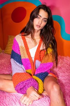 An employee favorite, this chunky knitted rainbow cardigan is guaranteed to brighten up your wardrobe. A dash of adorable style, this cardigan is lightweight, soft, and sure to keep you warm. 100% acrylic  Small, medium or large Knitted Rainbow, Chunky Sweaters, Rainbow Cardigan, Adorable Style, Astrology Jewelry, Best Winter Outfits, Clothing Pieces, Crystal Shoes, Midi Skirts