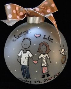 a glass ornament with an image of two people holding hands and the words dear liz on it