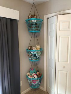 three baskets hanging from the ceiling in a room