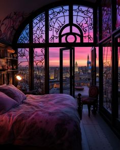 a bedroom with a large window overlooking the city at sunset or dawn, and a bed in front of it