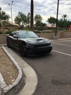 a black car is parked in the parking lot