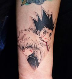 a couple of anime tattoos on someone's arm