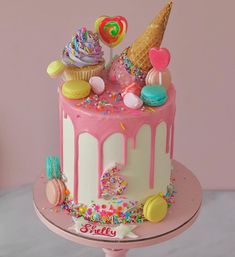 a birthday cake with ice cream, sprinkles and candies on it