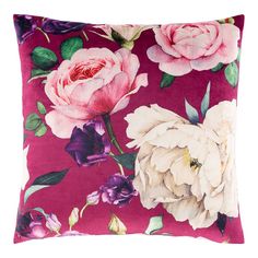 a pink and purple floral pillow with white flowers on the front, sitting on a white background