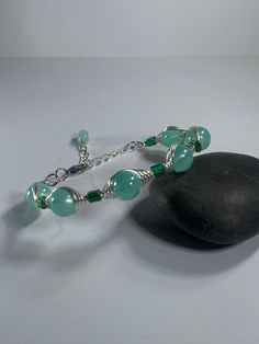 "Beautiful green Aventurine gemstone bracelet. Silver plated, adjustable. 6\"-8\" You receive the bracelet pictured with the coin purse." Adjustable Green Crystal Bracelet With Natural Stones, Handmade Green Aventurine Bracelets, Handmade Aventurine Bracelet, Adjustable Aventurine Beaded Bracelets, Adjustable Turquoise Aventurine Jewelry, Silver Aventurine Bracelet Jewelry, Handmade Aventurine Round Bracelets, Adjustable Green Aventurine Crystal Bracelet, Adjustable Silver Jade Crystal Bracelet