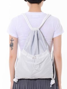 Editor's notesEx Nylon Gym Sack by PIECEMAKER is made of lightweight nylon material, which makes it convenient to carry around without adding much weight. On the front side of the bag, there is additional storage space provided using a stopper, allowing you to store extra items or accessories. The bag features a thick shoulder strap made with a special jacquard material, ensuring comfort while carrying it. As a visual accent, there is artwork logo embroidery on the front of the bag, adding a uni Nylon Gym Backpack, Daily Use Nylon Backpack Gym Bag, White Nylon Gym Bag, Versatile Nylon Gym Bag With Pockets, Versatile Nylon Backpack Gym Bag, Nylon Backpack Gym Bag For Daily Use, Nylon Gym Backpack For Daily Use, Versatile Nylon Gym Backpack, Breathable Nylon Backpack For Travel