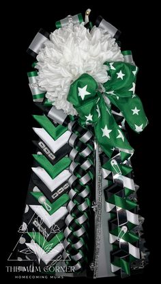 a green and white bow with stars on it