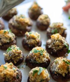 small appetizers with cheese and parsley on them are ready to be eaten