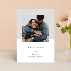 a white card with an image of a couple hugging