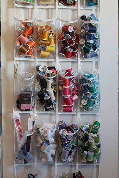 an organized craft room with spools of thread and scissors