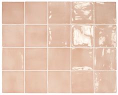 a white tile wall with different shades of pink and beige tiles on the bottom half