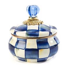 a blue and white checkerboard covered jar with a glass top on the lid