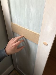 a person's hand reaching for something on the door