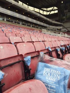 the seats in the stadium are covered with blue tarps and plastic bags that have been placed on them