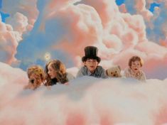 four children are sitting in the clouds with teddy bears