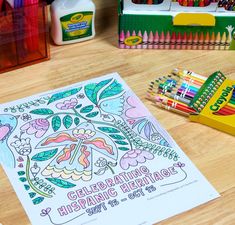 a coloring book and crayons on a table with markers, pencils, and other supplies