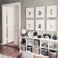 a living room filled with furniture and pictures on the wall