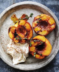 grilled peaches with yogurt and herbs on a plate