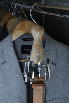 a suit and tie hangers on a rack