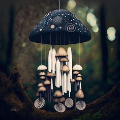 a group of mushrooms hanging from a tree in the forest with an umbrella shaped like a mushroom