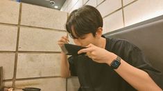 a young man sitting at a table eating food