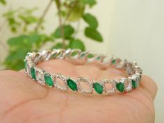 Natural emerald and diamond bracelet bangle for women and girls in 14k solid gold / surprised your love with this beautiful bangle bracelet With Gold / Gift Emerald Bangle Bracelet .... --------------------------------------------------------------------------------- Item description - stone - natural emerald shape - Marquise color - rich green luster weight - 9.10 carats Quality - AA size 3 mm width and 5 mm length total emerald stones - 24 pieces orgin - zambian material - 14k and 18k solid go Diamond Accents Bangle Bracelet Gift, Fine Jewelry Emerald Diamond Bracelet For Wedding, Emerald Diamond Bracelet For Wedding, Wedding Emerald Diamond Bracelet, Emerald Bangle Bracelet For Anniversary, Jeweled Round Bangle As Gift, Green Bangle Bracelet For Anniversary, Green Bangle Bracelets For Anniversary, Elegant May Birthstone Bangle For Gift