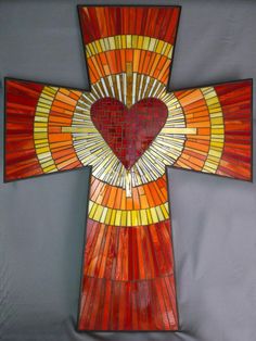 a stained glass cross with a heart on it