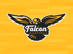 the falcon basketball logo is shown on a wooden floor with black and yellow wings above it