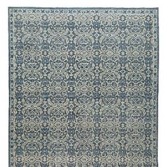 a blue and white rug with an intricate design