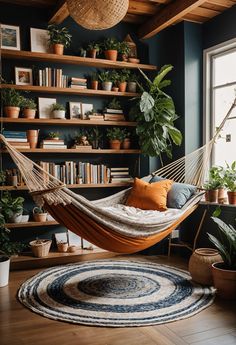 a hammock hanging from the ceiling in a room with potted plants and bookshelves