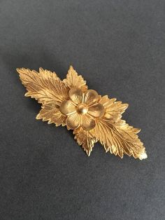 Andriani Vintage is pleased to offer for sale this wonderful  vintage Brooch. A wonderful Gold Gilt Look Brooch PinIn a floral design  with leaves In lovely vintage condition9.5cms.  X 4cms Great unusual items at a very affordable price. Vintage Yellow Gold Brooches For Ceremonial Use, Vintage Yellow Gold Brooches For Ceremonial Occasions, Vintage Yellow Gold Brooch For Ceremonial Use, Vintage Gold Brooches For Ceremonial Use, Ornate Gold Brooches For Vintage Events, Antique Flower Brooches For Wedding, Classic Gold Brooches For Vintage Events, Handmade Vintage Brooch For Anniversary, Handmade Vintage Brooches For Anniversary