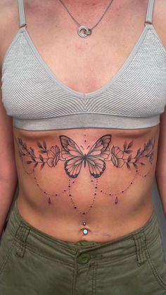 a woman with a butterfly tattoo on her stomach