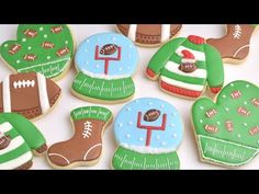 decorated cookies are arranged in the shape of footballs, mitts, and boots