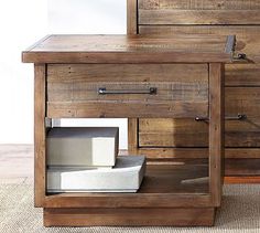 a wooden dresser with two drawers and one drawer open