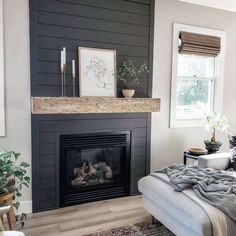 a living room with a fireplace and pictures on the wall