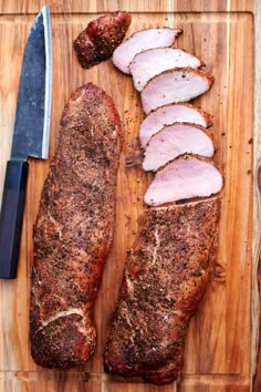 sliced ham on a cutting board next to a knife and some seasoning sprinkles