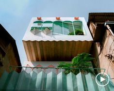 an apartment building with green glass balconies