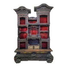 an ornate bookcase with red glass doors on the front and side panels, in bronze