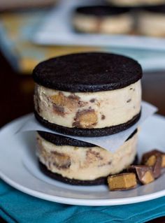 two cookies and oreo cookie sandwiches on a plate