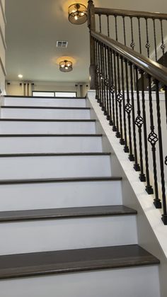 a set of stairs leading up to a second story window with light fixtures on either side