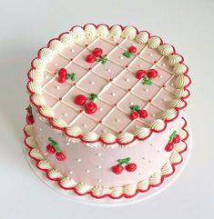 a cake with cherries on it sitting on a table