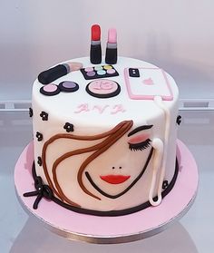 a cake decorated with makeup and beauty products